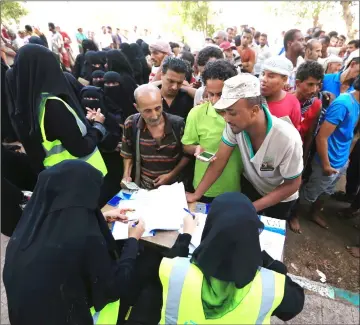  ??  ?? People gather at a United Nations aid distributi­on center in Hodeidah. — Reuters photo