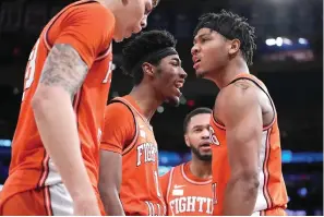  ?? (AP photo/ John Minchillo) ?? Illinois’ Terrence Shannon Jr., right, reacts after scoring and drawing a foul in overtime Tuesday during the team’s basketball game against Texas in the Jimmy V Classic in New York.