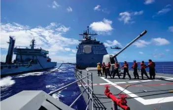  ?? ?? (Top) Exercise Malabar 2018 was hosted off the coast of Guam, designed to advance military-to-military coordinati­on in a multinatio­nal environmen­t between the US, Japan and Indian maritime forces; (above) US Sailors conduct an underway replenishm­ent (UNREP) training exercise with the Indian Navy oiler INS Shakti (A 57) during exercise Malabar.