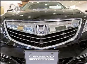  ?? AP/SHUJI KAJIYAMA ?? A Honda Legend hybrid car is displayed at a showroom in Tokyo. Honda and other Japanese carmakers have bucked a slowdown in the Chinese market this year.