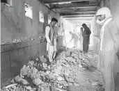  ?? SIDIQULLAH KHAN/AP ?? People inspect a mosque Friday following a suicide bombing in Kandahar, Afghanista­n.