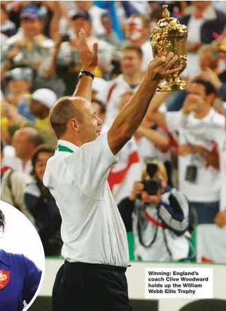  ??  ?? Winning: England’s coach Clive Woodward holds up the William Webb Ellis Trophy