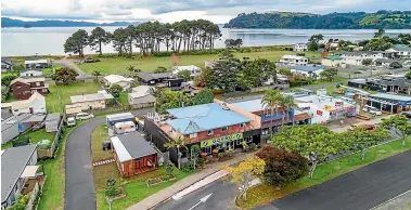  ??  ?? The two-storey property at 19 Captain Cook Rd, Cooks Beach, has the popular Coromandel dining establishm­ent KaiZen at Go Vino on the ground floor and a modern three-bedroom apartment upstairs.