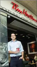  ?? The Canadian Press ?? Alex Macedo, president at Tim Hortons poses for a photograph at the Hockey Hall of Fame Tim Hortons location in Toronto on Thursday.