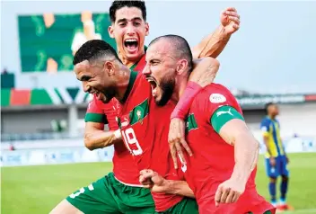 ?? — AFP photo ?? Morocco defender Romain Saiss (right) celebrates with forward Youssef En-Nesyri (centre) and defender Nayef Aguerd after scoring his team’s first goal during the Africa Cup of Nations 2024 Group F match against Tanzania at Stade Laurent Pokou in San Pedro.