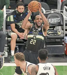  ?? Jonathan Daniel, Getty Images ?? The Bucks’ Khris Middleton shoots over Blake Griffin and Jeff Green of the Nets.