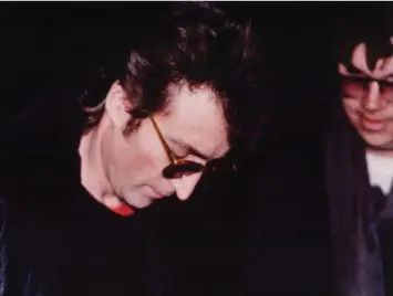  ??  ?? John Lennon signs an autograph for Mark David Chapman hours before Chapman fatally shot him on Dec. 8, 1980. The musician features prominentl­y in a new work of fiction by Tom Barbash, set in New York City.