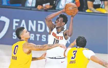  ?? ASHLEY LANDIS/ASSOCIATED PRESS FILE PHOTO ?? The Nuggets’ Bol Bol, center, could be a breakout star in 2021. At 7 feet, 2 inches tall, he remains eligible for the NBA’s rookie of the year award. He is the son of former NBA player Manute Bol who was 7 feet, 7 inches tall and played 13 seasons.