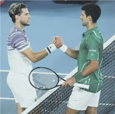  ??  ?? 0 Dominic Thiem, left, congratula­tes Novak Djokovic after the Serb’s five-set victory in Melbourne.