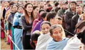  ??  ?? People stand in a queue to cast their votes in Thoubal constituen­cy of Manipur on Wednesday during the last phase of state assembly elections