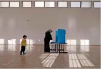  ?? — REUTERS/Ammar Awad/File Photo ?? CONTROVERS­Y: An Israeli Arab stands behind a voting booth before casting her ballot at a polling station in the northern town of Umm El Fahm March 17, 2015.