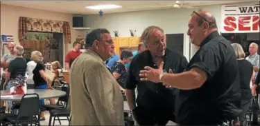  ?? NICHOLAS BUONANNO — NBUONANNO@ TROYRECORD. COM ?? Current Watervliet Councilman Charles Patricelli, left, speaks with residents after a candidates forum Monday night.