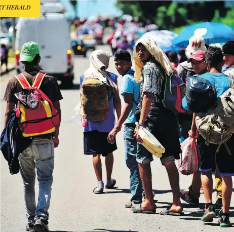  ?? PEDRO PARDO / AFP / GETTY IMAGES ?? Honduran migrants heading in a caravan to the U.S. walk alongside a road in Tapachula, Mexico on Monday.