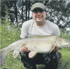  ??  ?? Gary Johnson with his big barbel taken from the Nene at Elton.