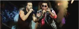  ?? — AP ?? In this file photo, singers Luis Fonsi, left and Daddy Yankee perform during the Latin Billboard Awards in Coral Gables, Fla.