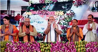  ?? PTI ?? Narendra Modi with Union Textiles Minister Smriti Irani, UP Governor Ram Naik and Chief Minister Yogi Adityanath and other leaders at the flag off ceremony of the Vadodara-Varanasi Mahamana Express in Varanasi on Friday. —