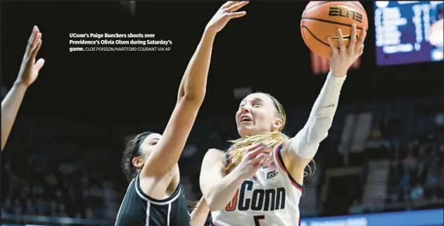  ?? CLOE POISSON/HARTFORD COURANT VIA AP ?? UConn’s Paige Bueckers shoots over Providence’s Olivia Olsen during Saturday’s game.