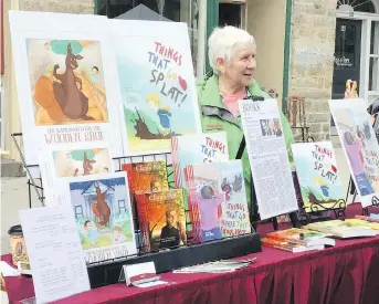  ??  ?? Anne Raina at Maple Fest in Perth, invited by the owner of the Book Nook to display and sell her books in front of her store.