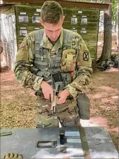  ?? U.S. Army photo ?? Spc. William Neumeister assembles and disassembl­es an M-17 Sig Sauer pistol during training for the Expert Soldier Badge at Fort Drum.