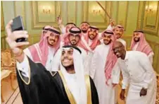  ??  ?? Saudi groom Basil Albani poses for a selfie with his friends during his wedding at his home in the Red Sea resort of Jeddah. — AFP photos