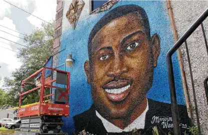  ?? Sarah Blake / Associated Press file photo ?? A mural of Ahmaud Arbery is on display in Brunswick, Ga., where the 25-year-old man was shot and killed in February 2020. The man who fatally shot Arbery took the witness stand to tell jurors he pulled the trigger, fearing for his own life.