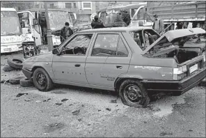  ?? AP ?? People inspect the damage Saturday at the site of two explosions in Damascus, Syria, in this photo released by the Syrian Arab News Agency.