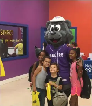  ?? KEVIN MARTIN — THE MORNING JOURNAL ?? Youngsters hang out with Lake Erie Crusher’s mascot Stomper after receiving new backpacks at the Back 2 School Bash on Aug. 25 at the Boys and Girls Clubs of Lorain County’s Desich Family Campus in collaborat­ion with Rising Titans.