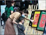  ?? PROVIDED TO CHINA DAILY ?? From left: Residents play ping-pong at a fitness room in Guanshanhu district in Guiyang. CHEN YANG / FOR CHINA DAILY Locals enjoy an art exhibition in Guiyang.