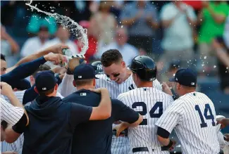  ?? NOAH K. MURRAY/ASSOCIATED PRESS ?? New York Yankees right fielder Aaron Judge celebrates with teammates after his walk-off home run against the Houston Astros during the 10th inning Sunday in New York. The Yankees won 6-3.