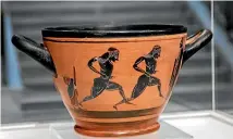  ?? AP ?? An ancient Greek drinking cup decorated with runners, which was one of the awards presented to Spyros Louis, the Greek winner of the marathon in the 1896 first modern Olympic Games in Athens.