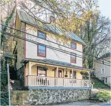  ??  ?? A covered front porch with a painted beadboard ceiling overlooks Main Street in Historic Ellicott City.