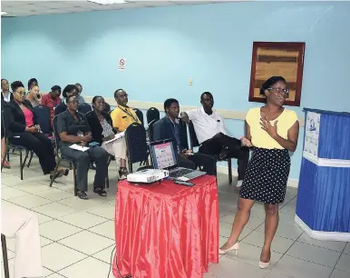  ??  ?? Kristen Rhone engages attendees at the Newport West disaster preparedne­ss presentati­on, held at the Shipping Associatio­n of Jamaica’s offices recently.
