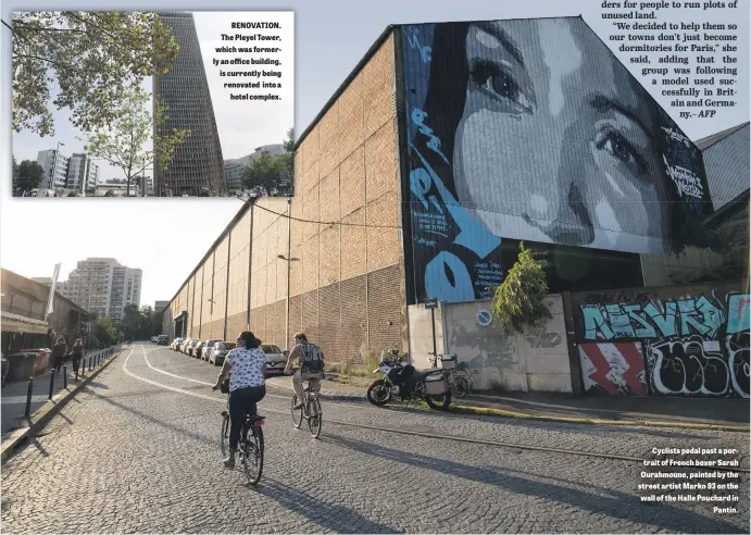  ??  ?? RENOVATION. The Pleyel Tower, which was formerly an office building, is currently being renovated into a hotel complex. Cyclists pedal past a portrait of French boxer Sarah Ourahmoune, painted by the street artist Marko 93 on the wall of the Halle Pouchard in Pantin.