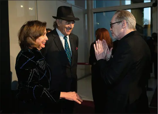  ?? KEVIN WOLF / ASSOCIATED PRESS ?? Rep. Nancy Pelosi, D-calif., left, and her husband, Paul Pelosi, talk with actor Steve Buscemi, right, as they arrive Sunday on the red carpet for the 24th Annual Mark Twain Prize for American Humor at the Kennedy Center for the Performing Arts in Washington. Pelosi has given up the 24/7 schedule of a party leader and now has to find new ways to fill her calendar because she has no committee assignment­s and loathes downtime. And as she’s traded in her leadership title for the honorific speaker emerita, Pelosi has lost the bulk of her staff and coveted office space.