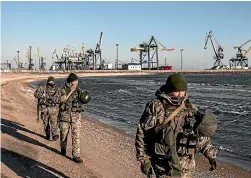  ?? MARTYN AIM/GETTY IMAGES) ?? Ukraine’s Border Security Force soldiers patrol the coast of the Azov Sea near Mariupol Port as President Poroshenko declares martial law in response to the attacking and seizing of three Ukrainian naval vessels by Russian forces this week.