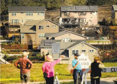  ?? Noah Berger / Special to The Chronicle ?? Residents check burned homes in the Skyhawk neighborho­od of Santa Rosa after the Glass Fire earlier this month. Insurers declined to renew 31% more homeowners policies statewide in 2019 compared with 2018.