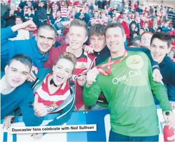  ??  ?? Doncaster fans celebrate with Neil Sullivan