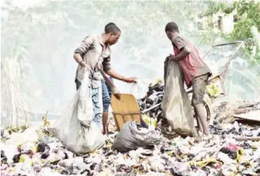  ?? ?? Scavengers at a dump site in Jabi, Abuja