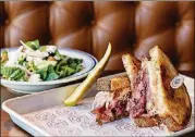  ??  ?? Coalition’s Reuben Sandwich boasts house-smoked pastrami with classic accouterme­nts.