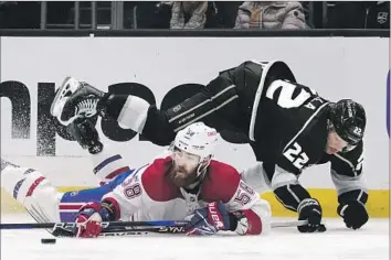  ?? Marcio Jose Sanchez Associated Press ?? THE CANADIENS’ David Savard (58) reaches for the puck as the Kings’ Kevin Fiala tumbles over him in the second period. The Kings have won three of four games and stayed tied for first with Vegas in the Pacific.
