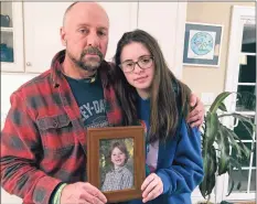  ?? Dave Collins / Associated Press ?? In this Dec. 3, 2019, photo, Mark Barden and his daughter Natalie Barden hold a photograph of Natalie’s late brother, Daniel, who died in the Dec. 14, 2012, Sandy Hook Elementary School shooting.