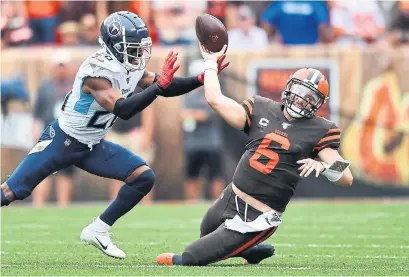  ?? JAMIE SABAU GETTY IMAGES ?? Cleveland quarterbac­k Baker Mayfield took several big hits. He had X-rays taken and left the stadium with his right wrist wrapped.