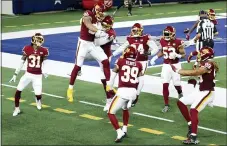  ?? ROGER STEINMAN — THE ASSOCIATED PRESS ?? Washington’s Montez Sweat, second from left, and Ryan Kerrigan (91) celebrate Sweat’s intercepti­on that Sweat ran back for a touchdown on Thursday. Kamren Curl (31), Jeremy Reaves (39), Daron Payne (94), Jon Bostic (53) and Chase Young (99) run to join the celebratio­n.