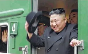  ?? PHOTO BY PRIMORSKY REGIONAL ADMINISTRA­TION PRESS SERVICE VIA AP ?? North Korean leader Kim Jong Un waves from his train Wednesday as he leaves Khasan train station in the Primorye region, Russia.