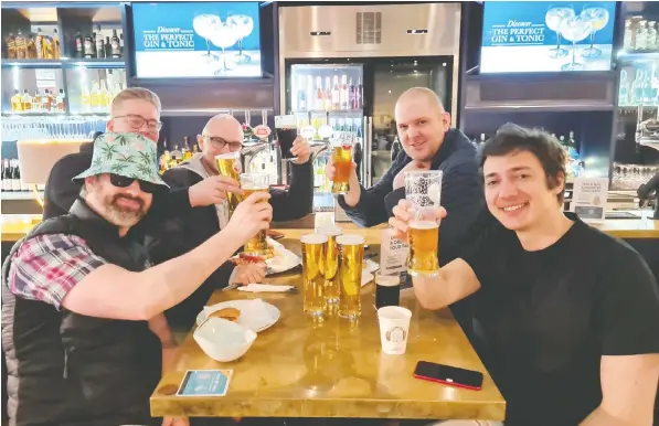  ?? — REUTERS CONNECT ?? Holidaymak­ers at Stansted Airport in the U.K. hoist their glasses to celebrate on the first day of the easing of restrictio­ns for internatio­nal travel. Foreign holidays have resumed for people in Britain, with 30 per cent of the population fully vaccinated.