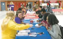  ?? ERIN SCHAFF/NEW YORK TIMES ?? Student volunteers register their classmates to vote last month at Brooke Point High School in Stafford, Va. The pace of new voter registrati­ons among young people in key states is accelerati­ng, a signal that the school walkouts and gun-control marches...