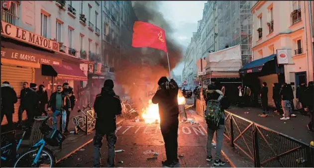  ?? AP ?? Mass shooting at a Kurdish center in Paris sparks demonstrat­ion Friday night. Police (below) were called in and fired tear gas to disperse an agitated crowd.