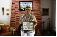  ?? CARLOS GIUSTI / ASSOCIATED PRESS ?? Nerybelle Perez shows a portrait of her father, World War II veteran Efrain Perez, who died in an ambulance after being turned away from a hospital in Puerto Rico days after Hurricane Maria passed.