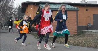  ?? Photo by Matthew Liebenberg/Prairie Post ?? The Langager team participat­ed over the two-kilometre distance at the Zombie Fun Run, Oct. 29. From left to right, Brooke, Chloe and Leanne Langager get going from the starting line.