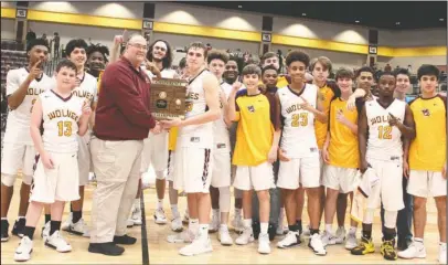 ?? The Sentinel-Record/James Leigh ?? 6A-WEST CHAMPS: Lake Hamilton Superinten­dent Steve Anderson presents the 6A-West Conference trophy to the Lake Hamilton Wolves after they defeated Benton in the conference finals Saturday night at Wolf Arena.